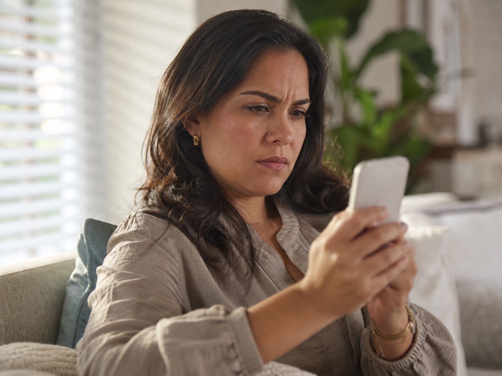 A customer on a couch, puzzled by a message that doesn't feel right