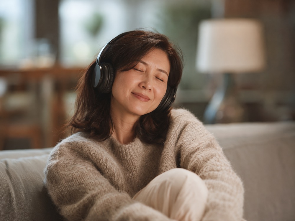 A customer relaxed on a couch, eyes closed, genuinely moved